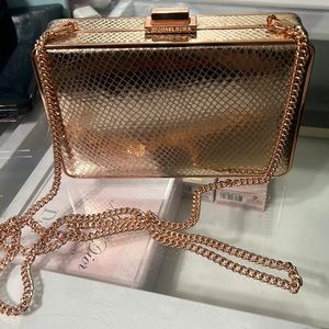 Michael kits rose gold small clutch on a chain